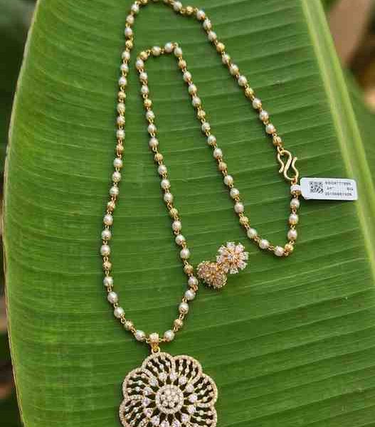 Premium AD Stone Goldfinish Pendent With Pearl Chain and Matching Earrings